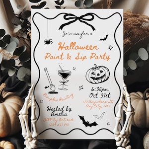 May include: A Halloween-themed invitation with a black and white border, featuring orange text that reads "Halloween Paint & Sip Party." The invitation includes illustrations of a spider, bat, pumpkin, and cocktail. The event details are also included.
