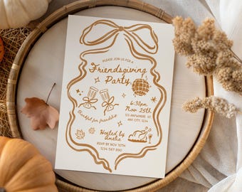 May include: Cream-colored Friendsgiving party invitation with gold-colored illustrations and text. The design includes a bow, disco ball, champagne glasses, and a roasted turkey. The invitation is on a wooden tray with pumpkins and fall foliage.