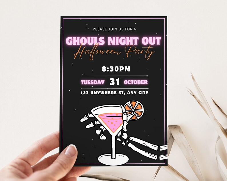 May include: A black and white invitation with pink neon text that reads "Ghouls Night Out Halloween Party". The invitation includes the date and time of the party, "Tuesday 31 October, 8:30PM", and the location, "123 Anywhere St, Any City". The invitation also features a black and white illustration of a martini glass with a pink drink and a lemon slice, held by a skeletal hand.