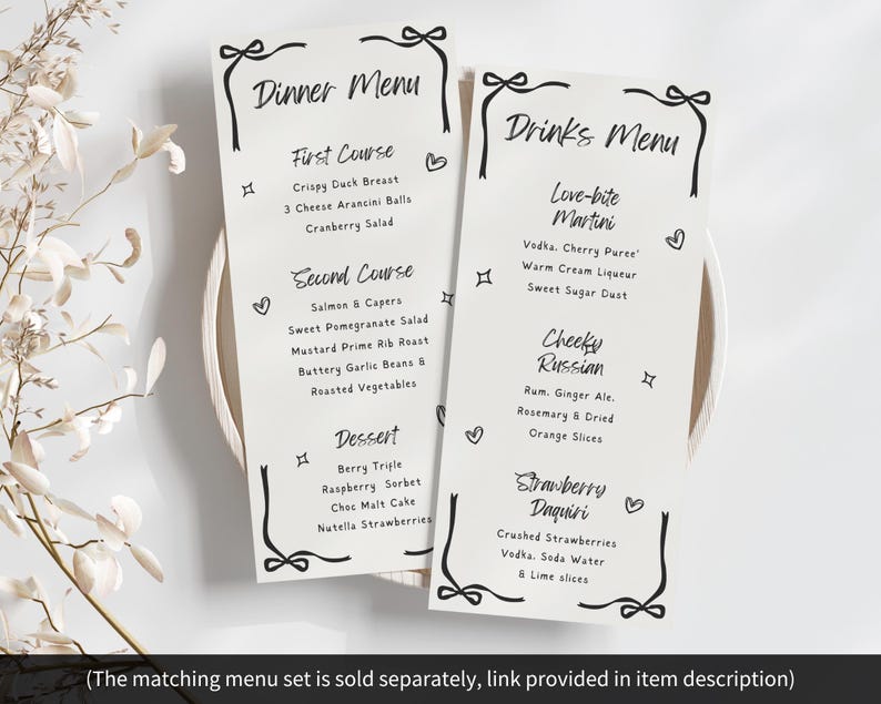May include: Two elegant menu cards with black script, one labeled "Dinner Menu" and the other "Drinks Menu." The dinner menu lists courses like Crispy Duck Breast and Berry Trifle. The drinks menu features cocktails like Love-bite Martini and Strawberry Daquiri.