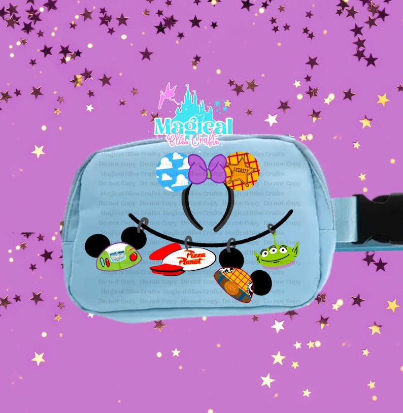 May include: A light blue fanny pack with a black buckle, adorned with cartoon character designs. The pack features a Mickey Mouse ear headband with a purple bow and various character-themed charms, including a Pizza Planet sign.