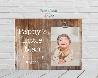 May include: A rustic wood sign with the text "Pappy's Little Man -Kayden-" and a photo of a baby boy in a brown and white striped hat smiling.