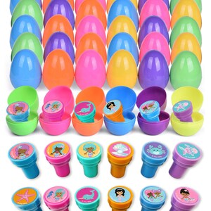May include: Set of 24 colourful plastic eggs with 16 mermaid themed stamps. The eggs are in various colours, including green, purple, pink, blue, and orange. The stamps feature mermaids, seahorses, seashells, and crabs.
