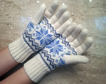 May include: A pair of white knitted gloves with a blue and white snowflake pattern.