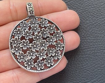 Colgante floral chapado en plata mate, pieza de joyería redonda calada con múltiples flores, 480B