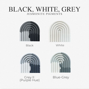 May include: Four arched, ribbed Jesmonite pigment samples labeled Black, White, Grey II (Purple Hue), and Blue-Grey. The text at the top reads BLACK, WHITE, GREY JESMONITE PIGMENTS. Each sample displays a distinct color variation or solid tone.