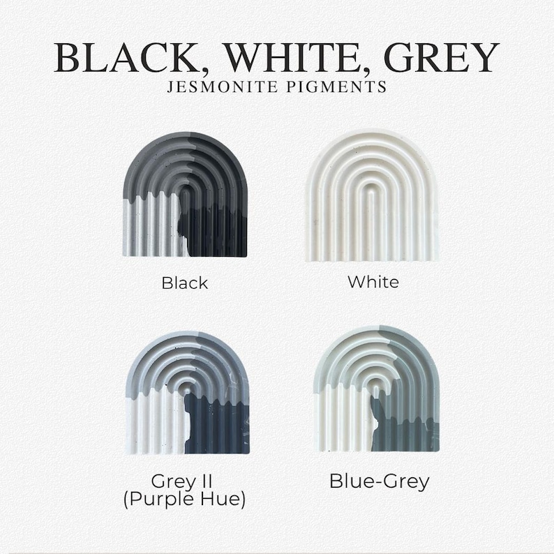 May include: Four arched, ribbed Jesmonite pigment samples labeled Black, White, Grey II (Purple Hue), and Blue-Grey. The text at the top reads BLACK, WHITE, GREY JESMONITE PIGMENTS. Each sample displays a distinct color variation or solid tone.