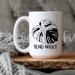 May include: White ceramic mug with a black and white monstera leaf design and the text "Send Nodes".