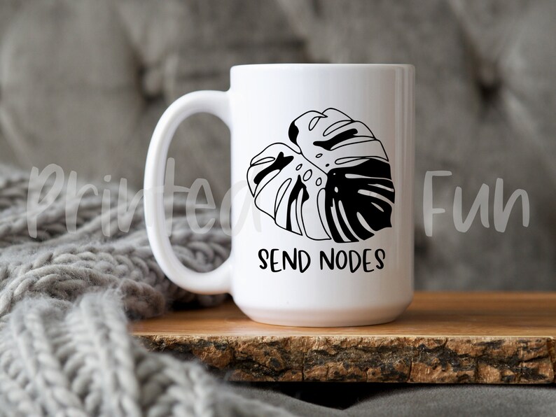 May include: White ceramic mug with a black and white monstera leaf design and the text "Send Nodes".