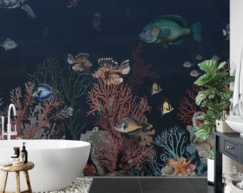 May include: A bathroom with a dark blue underwater mural featuring fish, coral, and a sea turtle. A white, oval bathtub is in front of the mural, with a small wooden stool and a plant to the side. The floor is black tile.