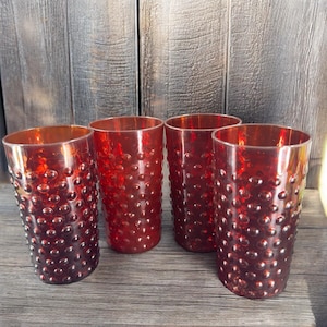 May include: Set of four red glass tumblers with a textured bubble design.