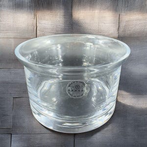 May include: A clear glass bowl with a thick rim and a label that reads "Lead Free Crystal Barski Made in Poland".