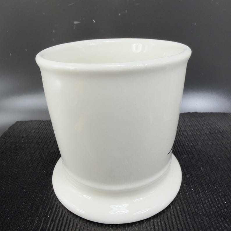 May include: A set of three ceramic mugs with a speckled, matte finish. The mugs are in shades of cream, light gray, and dark gray. Each mug has a simple, minimalist design, perfect for coffee or tea.