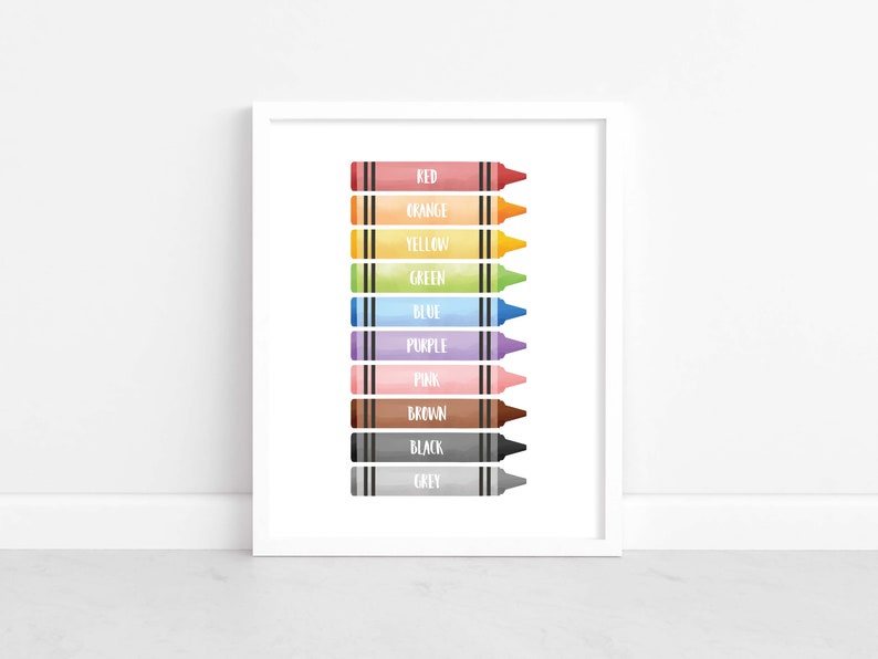 May include: A framed print featuring a watercolor illustration of ten crayons in various colors, including red, orange, yellow, green, blue, purple, pink, brown, black, and grey. Each crayon is labeled with its corresponding color name in white text.