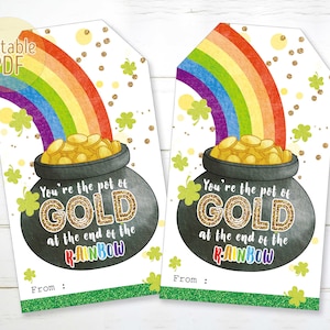 May include: Two St. Patrick's Day gift tags with a rainbow, pot of gold, and the text "You're the pot of GOLD at the end of the RAINBOW." The tags have a green glitter border and shamrock accents. The words "Editable PDF" are in the upper left corner.