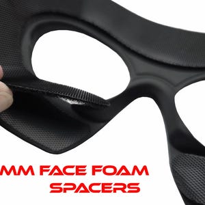 May include: Close-up of a black foam spacer with a textured surface. The text "2MM FACE FOAM SPACERS" is displayed in red. The spacer is designed to fit around the eyes.