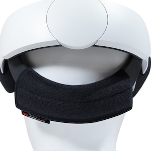 May include: White VR headset with a black padded headband. The headband has the text "Studio Series Creative VR" printed on it.