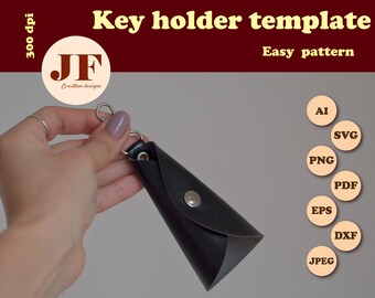 May include: A black leather key holder with a silver metal ring and a snap closure. The key holder is shaped like a cone and is being held by a hand. The image includes the text "Key holder template" and "Easy pattern".