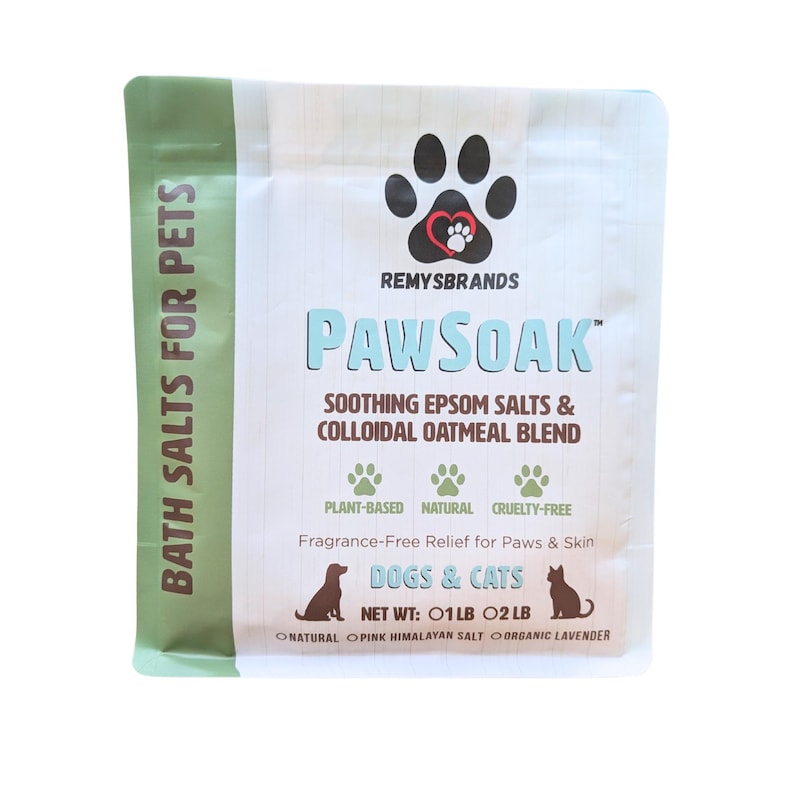 May include: A green and white pouch with the text "BATH SALTS FOR PETS" on the left side. The pouch contains Paw Soak soothing Epsom salts and colloidal oatmeal blend for dogs and cats. The text "NET WT: 01LB 02LB" is visible on the pouch.