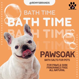 May include: A white French bulldog with its tongue sticking out, looking happy. The dog is in front of a peach-coloured background with the text "BATH TIME" repeated multiple times. The text "PAWSOAK BATH SALTS FOR PETS" is also on the background. Below that, the text "FOR PAWS & SKIN FRAGRANCE FREE ALL NATURAL" is displayed.