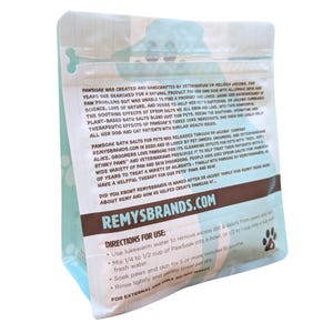 May include: A brown and blue resealable pouch with a white label. The label has the text "PawSoak" and "Remysbrands.com". The label also includes directions for use, including mixing 1/4 to 1/2 cup of PawSoak into a bowl of fresh water and soaking paws for 5 or more minutes.