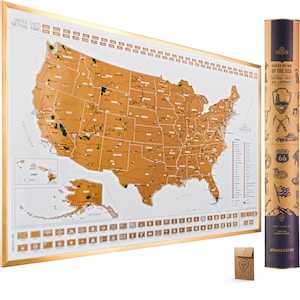May include: A gold scratch-off map of the United States featuring a list of national parks and landmarks. The map is framed in gold and comes with a small brown envelope containing a pin. The map is rolled up in a brown tube with a label that reads "Scratch Off Map of the USA National Parks and Landmarks".