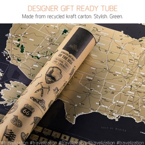 May include: A brown cardboard tube with a gold map of the United States on it. The map is a scratch-off map with the text "Scratch Off Map of the USA National Parks and Landmarks". The tube is rolled up and has a brown paper label with the text "Route 66" on it.