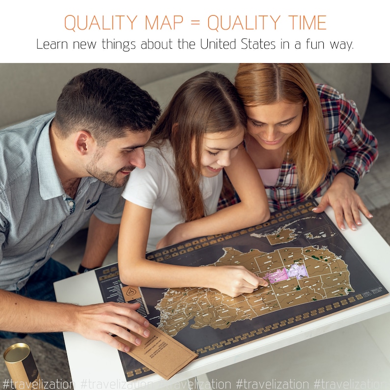 May include: A family of three, a man, a woman, and a girl, are looking at a black scratch-off map of the United States. The map is on a white table. The girl is pointing at a state on the map. The text on the map reads "QUALITY MAP = QUALITY TIME". The text below the map reads "Learn new things about the United States in a fun way."