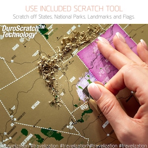 May include: A gold scratch-off map of the United States with a hand holding a tool to scratch off the gold foil. The map shows states, national parks, and landmarks. The text "DuroScratch&trade; Technology" is at the top of the map.