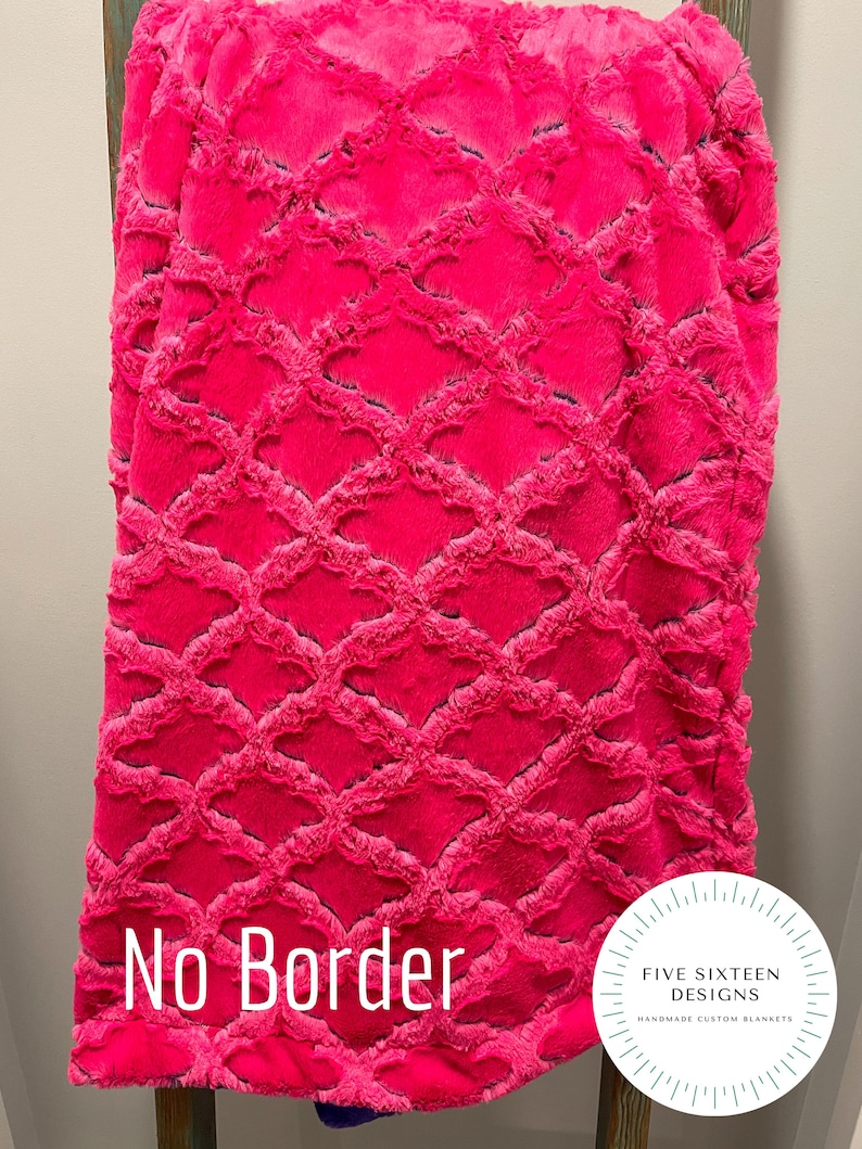 May include: A vibrant pink blanket with a textured, diamond-patterned design. The blanket is displayed on a wooden ladder. The text "No Border" is visible. The blanket is from Five Sixteen Designs, handmade custom blankets.