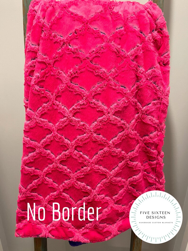 May include: A vibrant pink blanket with a textured, diamond-patterned design. The blanket is displayed on a wooden ladder. The text "No Border" is visible. The blanket is from Five Sixteen Designs, handmade custom blankets.