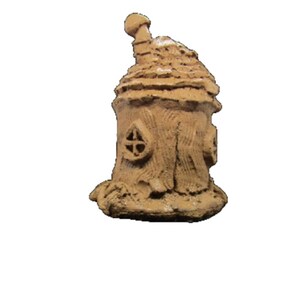May include: A small, brown, clay fairy house with a rounded roof and a chimney. The house has a small window and is decorated with a textured surface.