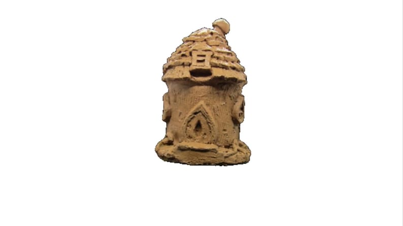 May include: A small, brown clay house with a pointed roof and a chimney. The house has a small door and windows, and is decorated with details like a fence and a flower.