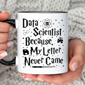 May include: White ceramic mug with a black rim and handle. The mug features a black graphic with the text "Data Scientist Because My Letter Never Came" and various Harry Potter-themed symbols.