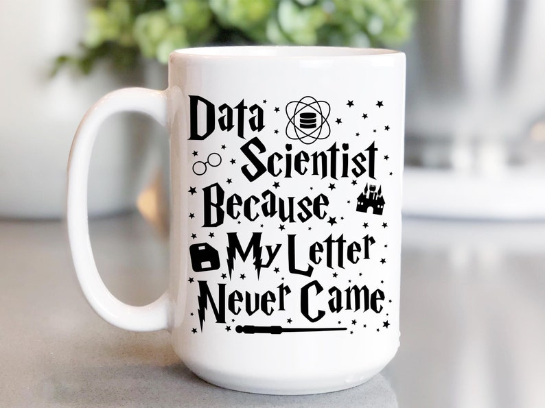 May include: White ceramic mug with a black design that reads "Data Scientist Because My Letter Never Came." The design includes a wizard's hat, glasses, a wand, a castle, and a database symbol.