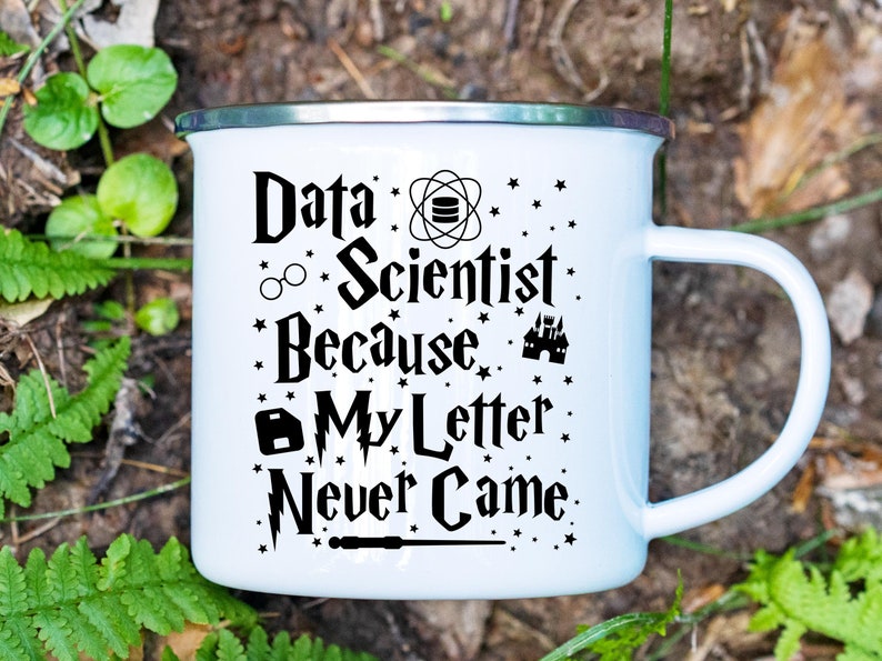 May include: White enamel mug with a black design that reads "Data Scientist Because My Letter Never Came." The design includes a database symbol, glasses, a castle, a lock, and a lightning bolt.