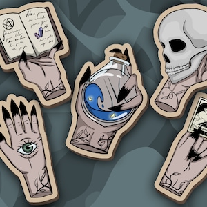 Porte-clés en forme de mains de sorcières en bois  - Main de sorcière - Crâne / Potion magique / Grimoire / Carte / Œil