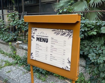 May include: A brown metal sign with a white background and black text. The sign says "Restaurant Menu" and lists various food items with prices. The sign is mounted on a brown metal stand.