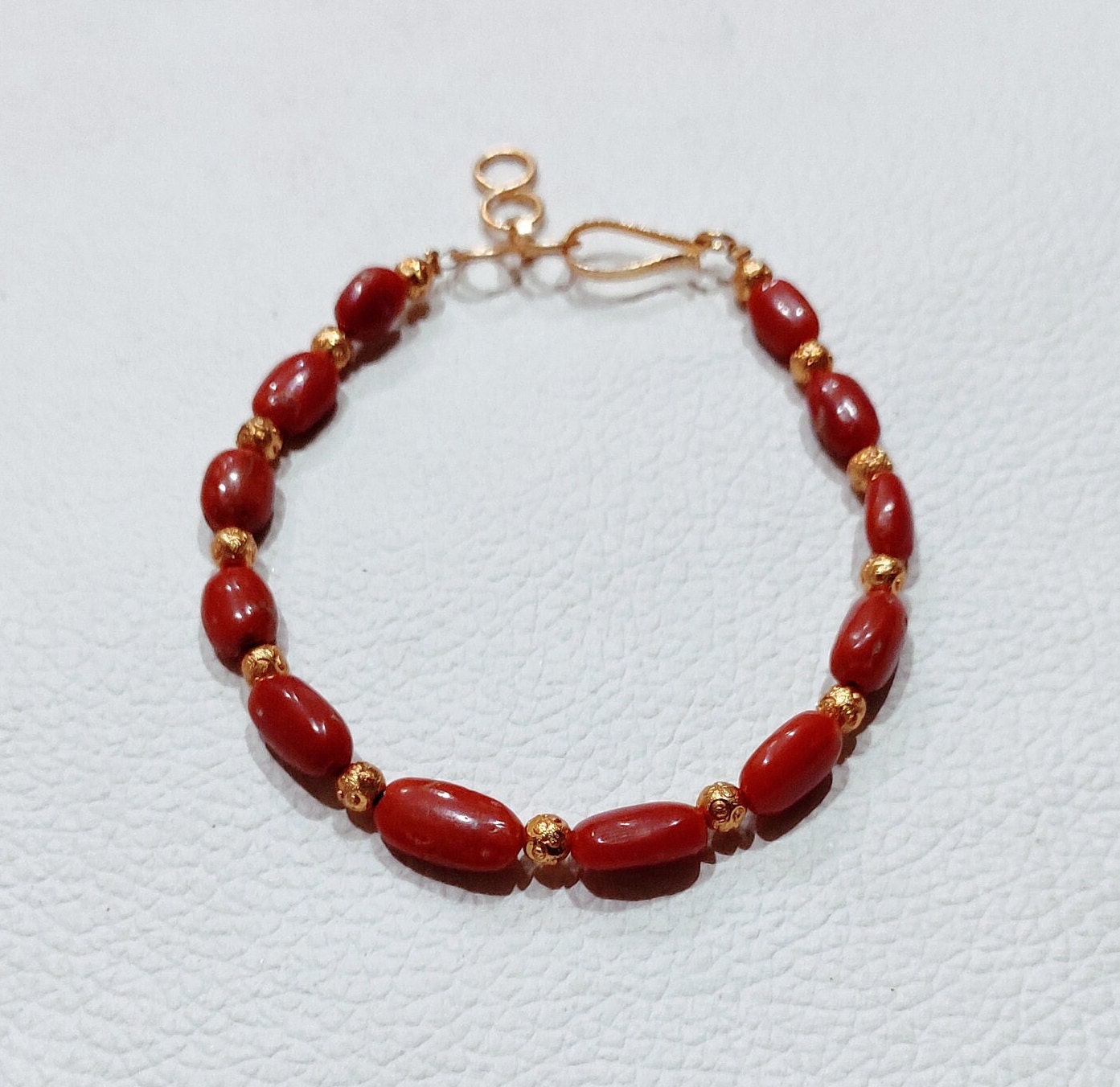 Red coral bracelet for baby meaning sale