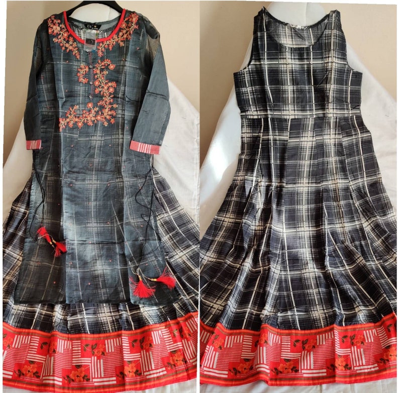 May include: Two black and white plaid dresses with red and white trim. The dress on the left has embroidered details on the bodice.