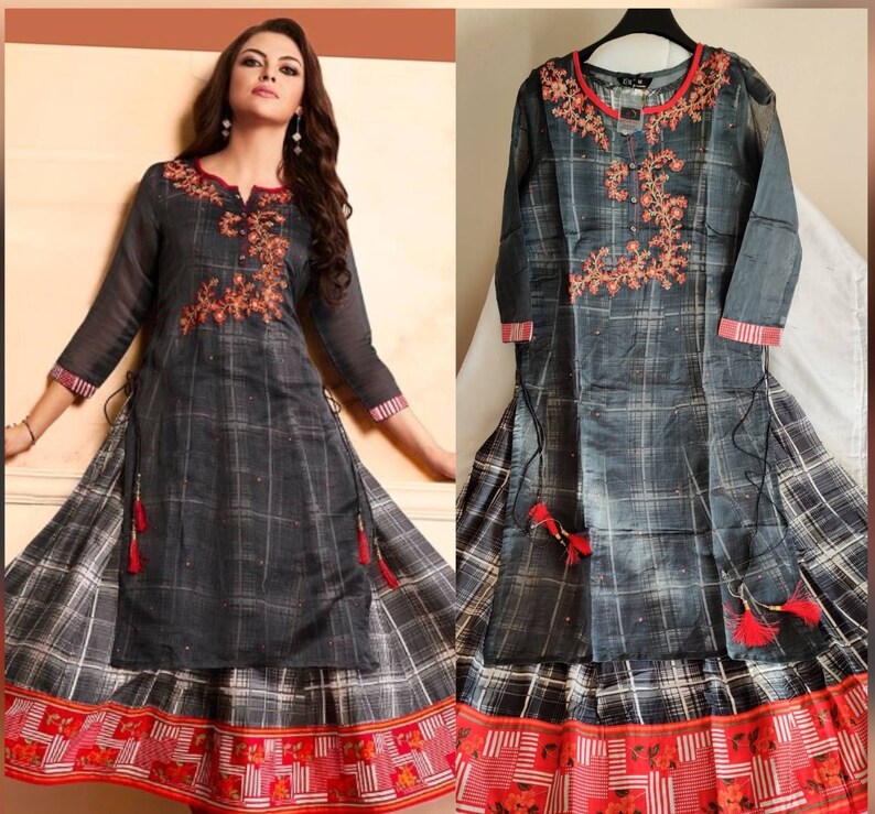 May include: A gray and white plaid long-sleeved dress with red embroidery and a red and white trim. The dress has a long skirt with a layered design.