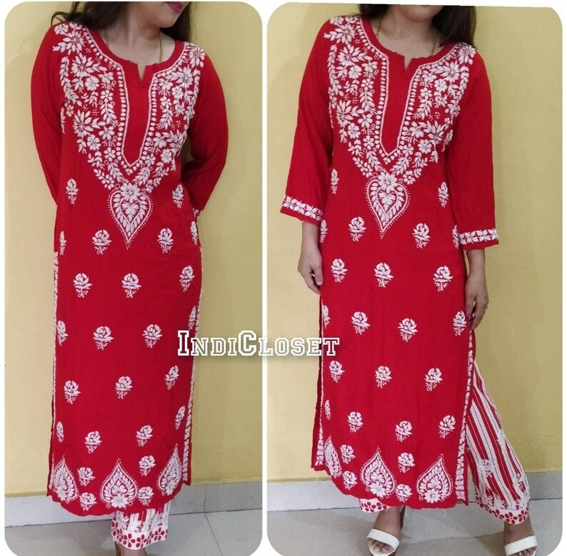 May include: A red and white embroidered kurta with a white floral pattern. The kurta is long and has a V-neck. The pants are white with red and white stripes. The text "INDIcloset" is visible in the image.