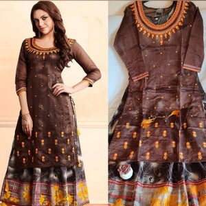 May include: A brown long-sleeved dress with embroidery and a matching skirt. The dress has a high neckline and a side slit. The skirt has a floral print.