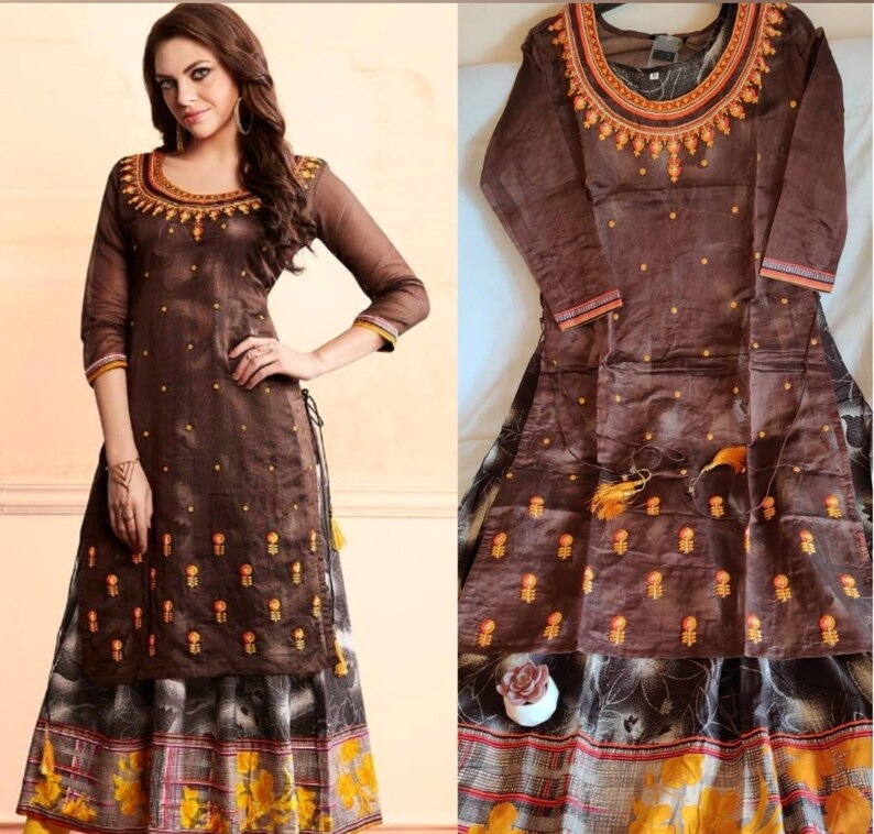 May include: A brown long-sleeved dress with embroidery and a matching skirt. The dress has a high neckline and a side slit. The skirt has a floral print.