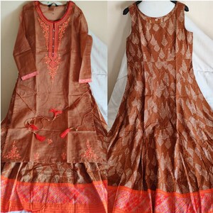 May include: Two brown cotton dresses with embroidered details. The dress on the left has long sleeves and a high neckline. The dress on the right is sleeveless and has a round neckline. Both dresses have a red and orange border at the bottom.