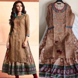 May include: A brown long-sleeved dress with a floral embroidered design and a matching skirt. The skirt has a white floral print and a colorful border.