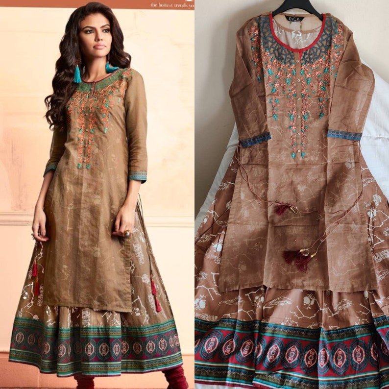 May include: A brown long-sleeved dress with a floral embroidered design and a matching skirt. The skirt has a white floral print and a colorful border.