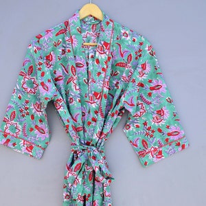 May include: A green floral print robe with a red and purple floral pattern. The robe has a tie belt and long sleeves.