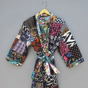 May include: A black quilted robe with a colorful patchwork design. The robe has a tie belt and long sleeves.