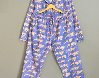 May include: A blue pajama set with a white trim and a pattern of colorful tigers. The set includes a long-sleeved top and matching pants.